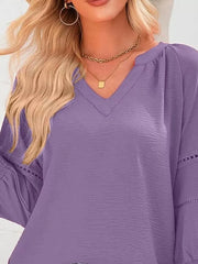 Purple polyester blouse with V-neck, smocked details, and eyelet trim on sleeves.