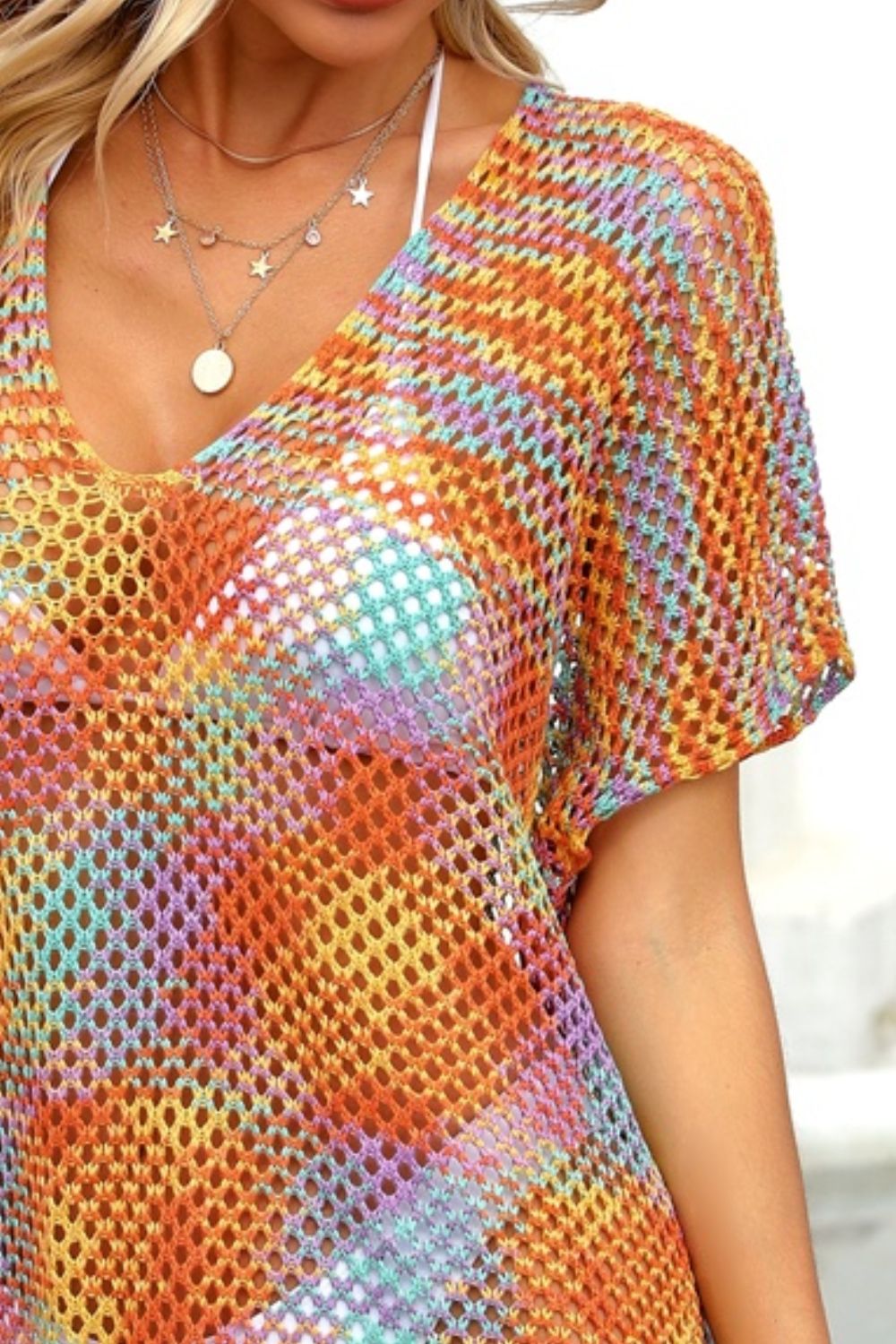 Open-knit caftan with V-neck and short sleeves in a rainbow stripe pattern.