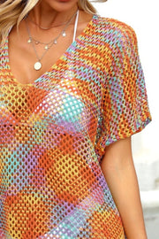 Open-knit caftan with V-neck and short sleeves in a rainbow stripe pattern.