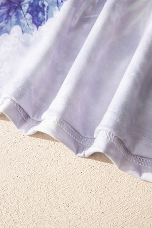Tunic tee with faded blue and white abstract print, crew neck, and visible stitching detail.