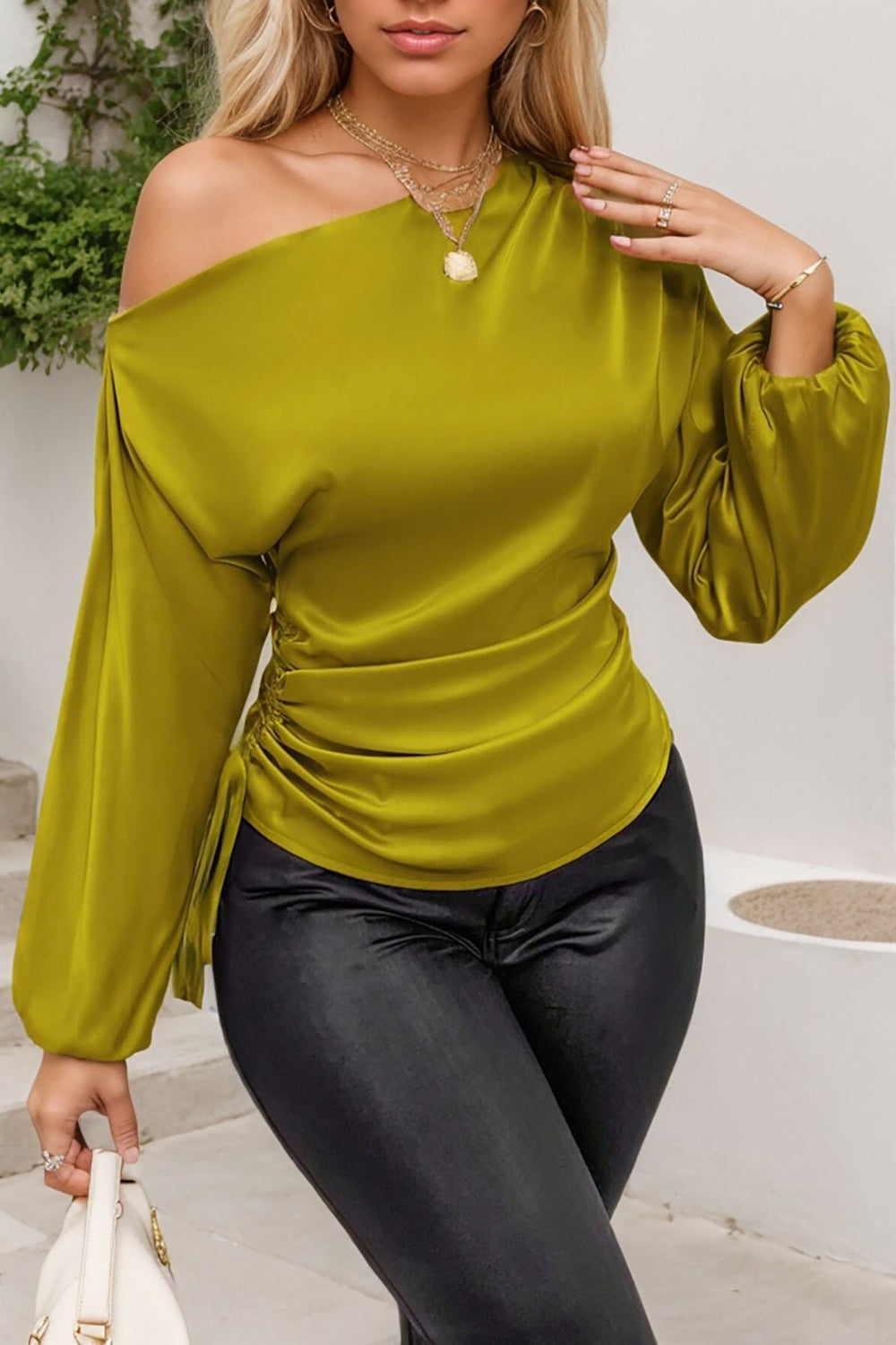 Matcha green asymmetric blouse with drape-front and ruched side detail.
