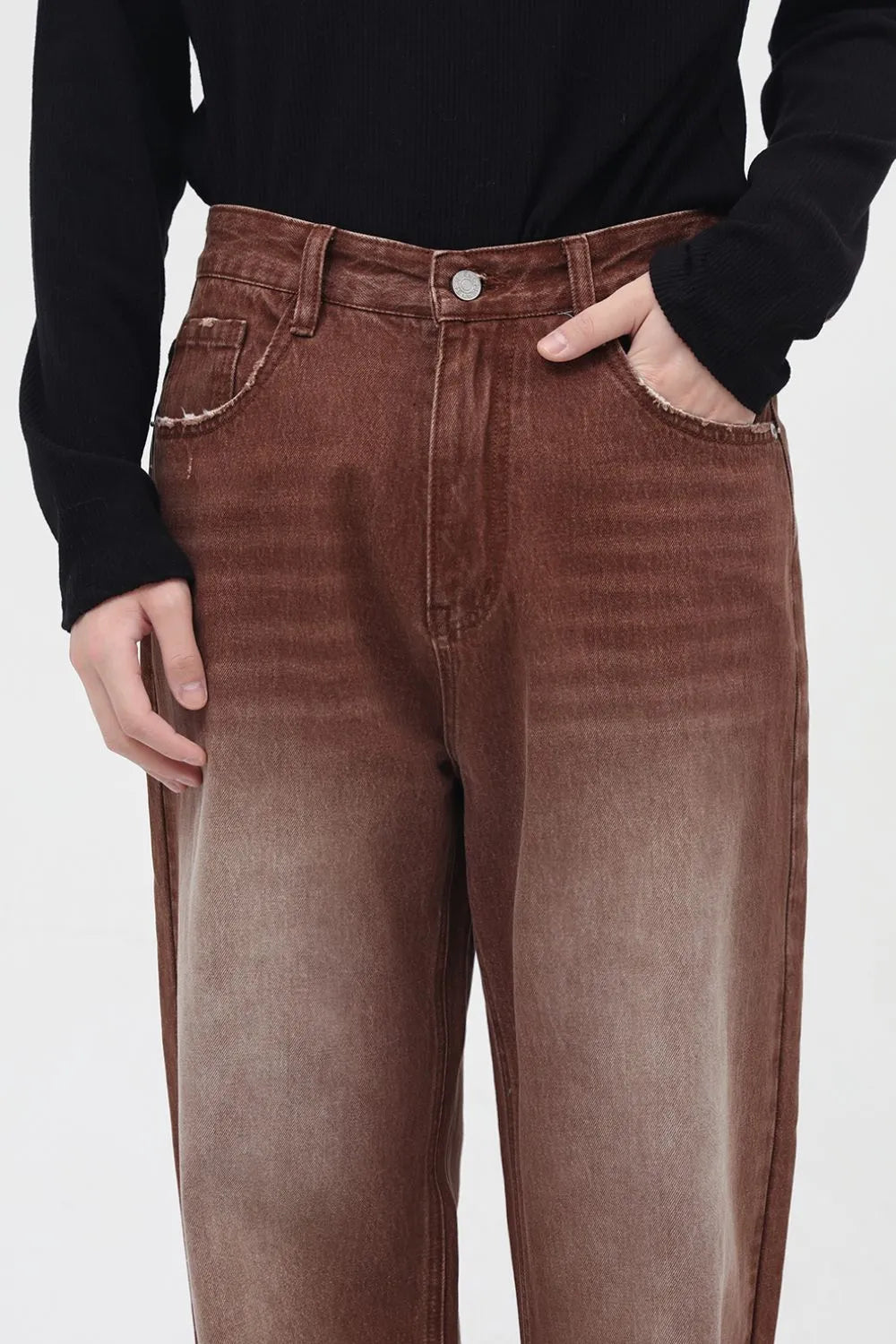 Brown faded wash wide leg denim trousers with distressed pocket details.
