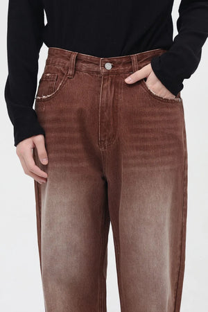 Brown faded wash wide leg denim trousers with distressed pocket details.