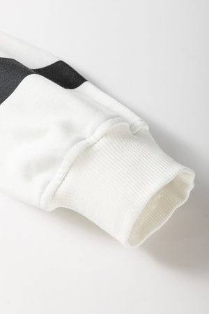 White loungewear set sleeve with black stripes and ribbed cuff detail