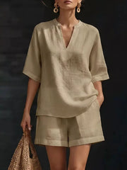 Khaki linen oversized two-piece set with V-neck top and cuffed shorts.