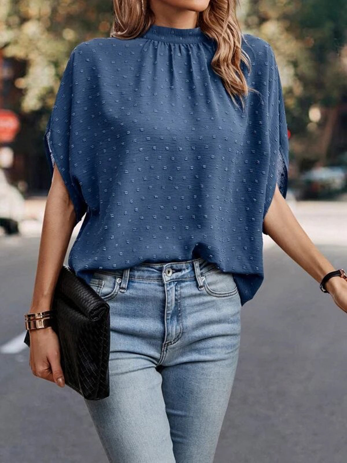 Dusty blue textured dot back-tie blouse with mock neck and short sleeves
