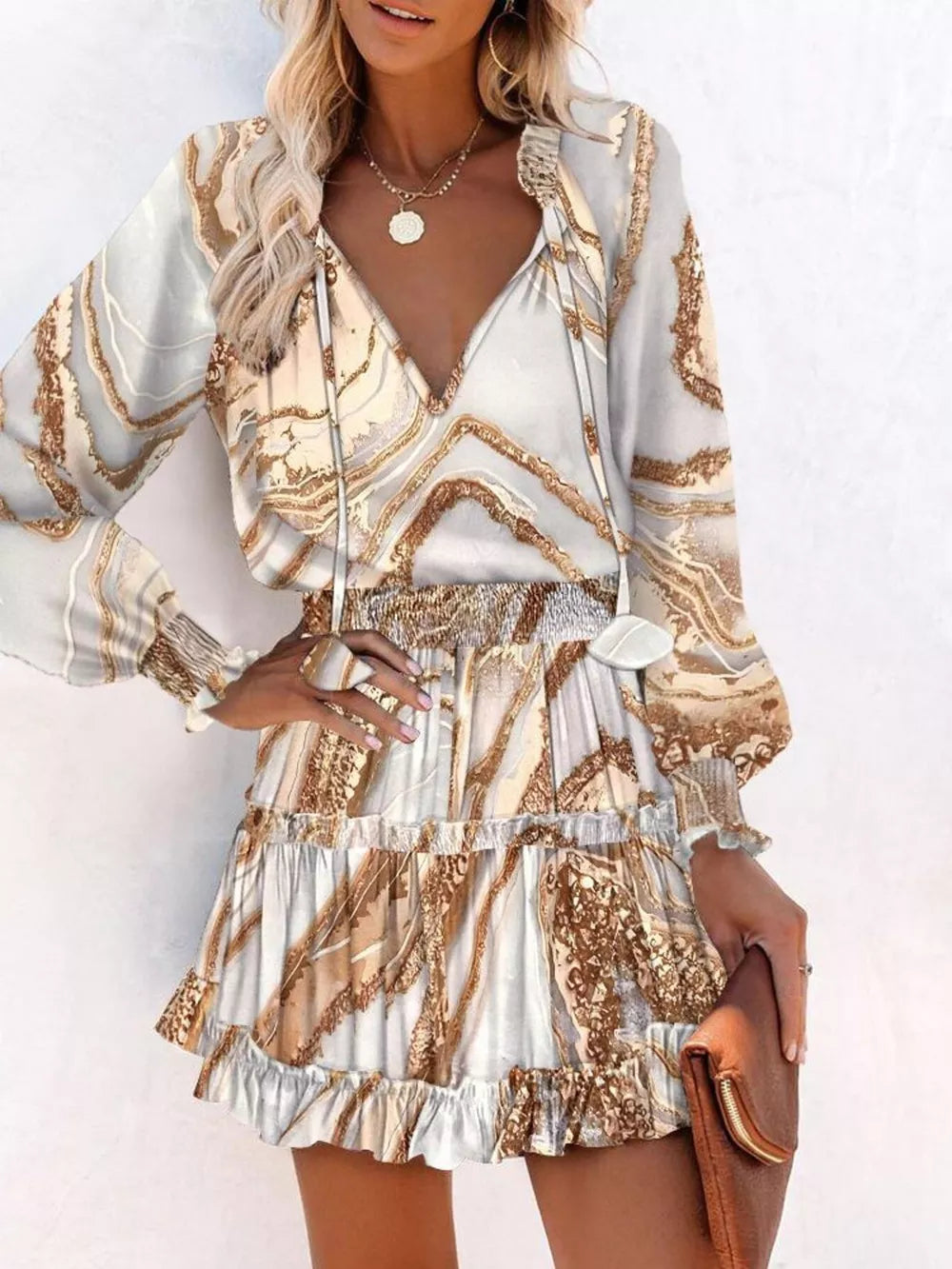 Abstract speckled tiered mini dress with ruffles and smocked waist in a marble-like print.