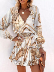 Abstract speckled tiered mini dress with ruffles and smocked waist in a marble-like print.