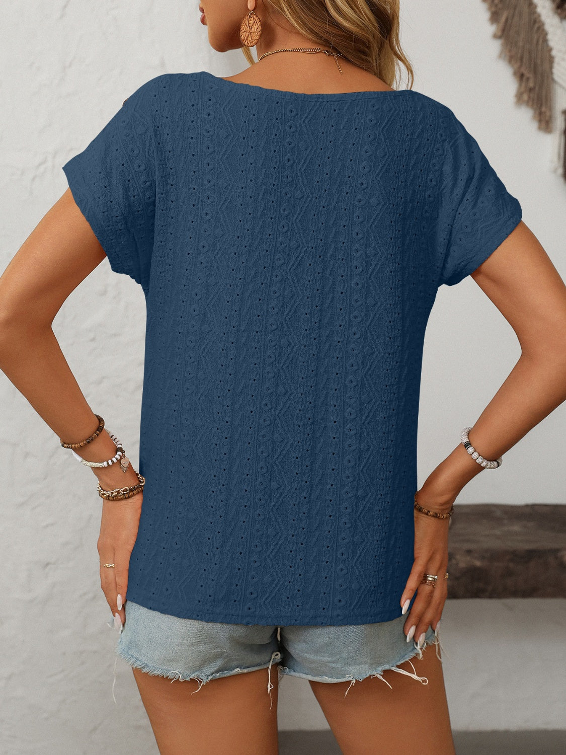 French blue eyelet knit tee with short sleeves and a boat neck.