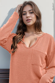 Coral ribbed plunge neck top with pocket detail