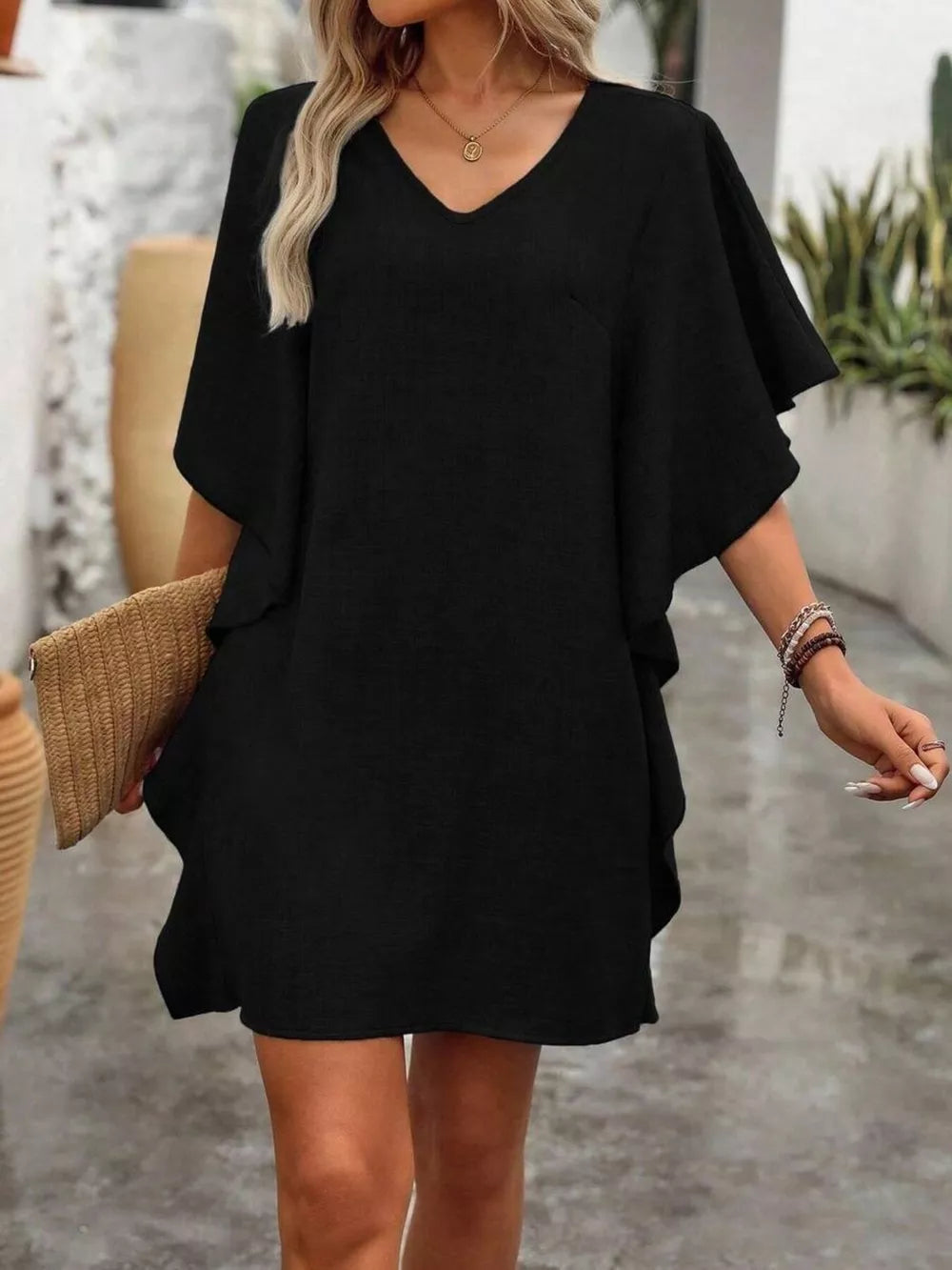 Black mini dress with V-neck and ruffled sleeves, casual style