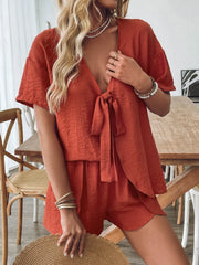 Terracotta linen tie-front lounge set with short sleeves and shorts.