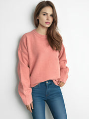 Oversized crewneck knit pullover sweater in burnt coral, acrylic, with ribbed cuffs and hem.