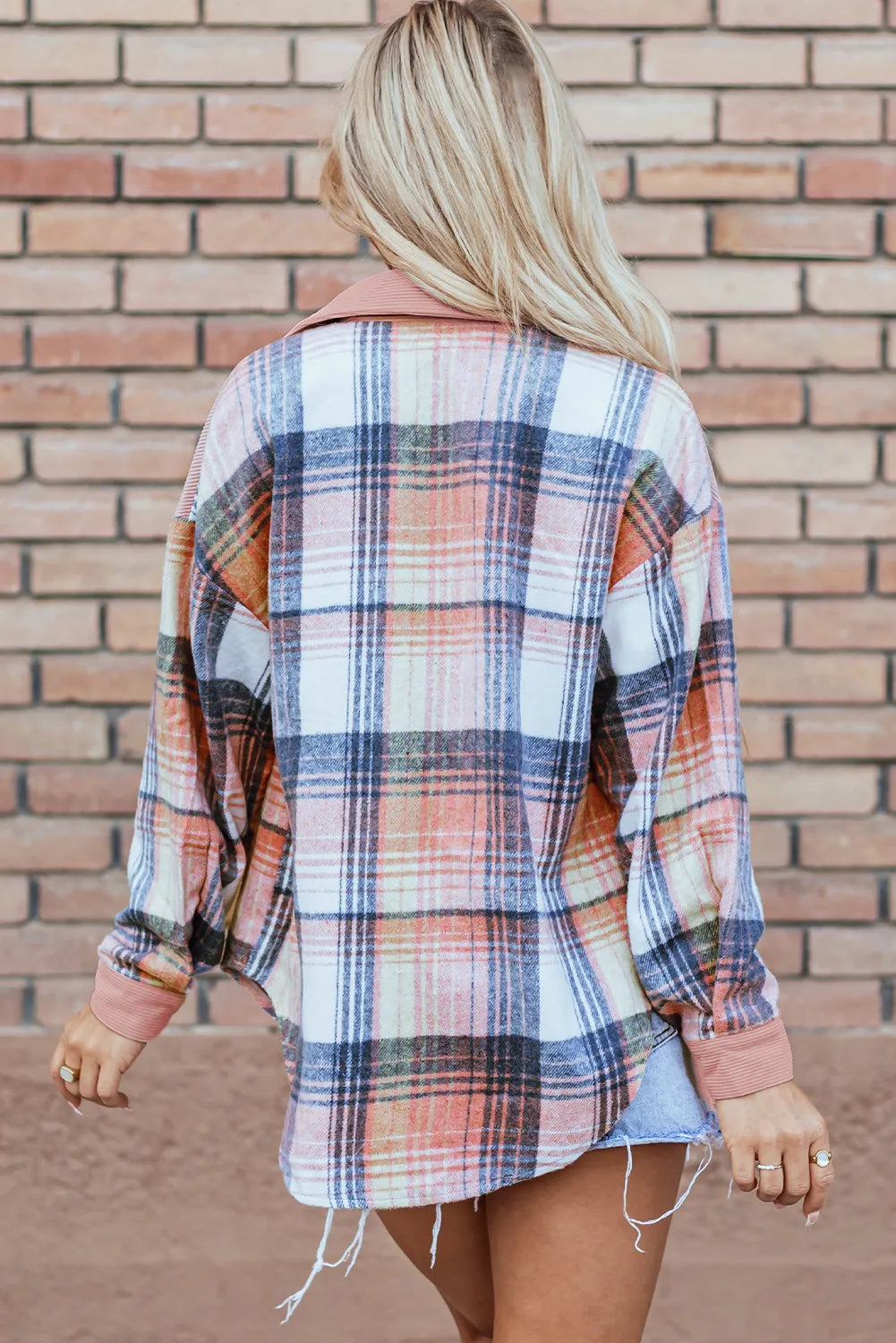 Colorblock plaid shacket with ribbed collar and cuffs, featuring pink, blue, and orange tones.