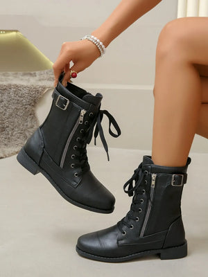 Black combat boots with side zipper detail and buckle strap.
