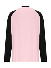 Blush pink long sleeve t-shirt with black raglan sleeves and round neck.