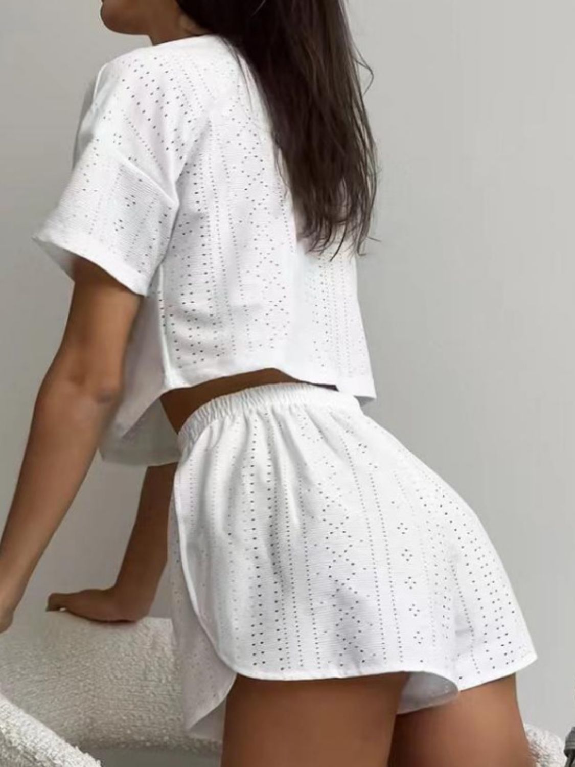 White perforated crop top and shorts set with elastic waist shorts and short sleeves.