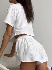 White perforated crop top and shorts set with elastic waist shorts and short sleeves.