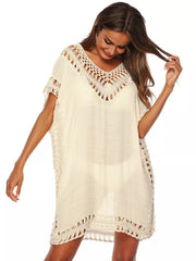White crochet v-neck cover-up dress with fringe trim and cutout details.
