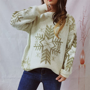 Cream knit sweater with gold snowflake embellishments and crewneck.