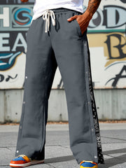 Men's dark gray wide leg sweatpants with side snaps and bandana print detail.