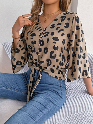Khaki leopard print tie-front blouse with button detail and bell sleeves.