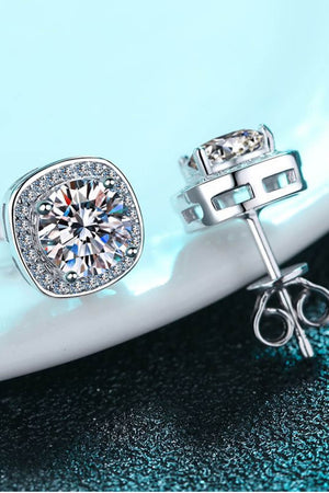 Silver cushion cut halo moissanite stud earrings with sparkling accents.