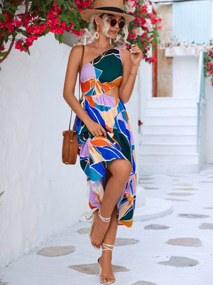 Abstract cutout midi dress with one-shoulder neckline and colorful geometric print.