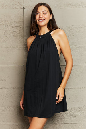 Black halter mini dress with gathered neckline and open back detail.
