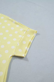Pastel yellow polka dot polyester top with short sleeves and a crew neck.