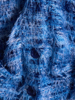 Blue textured knit cardigan with fuzzy yarn and dark buttons