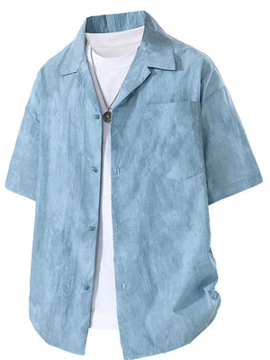 Blue relaxed fit camp collar men's shirt with turquoise buttons and a white undershirt.