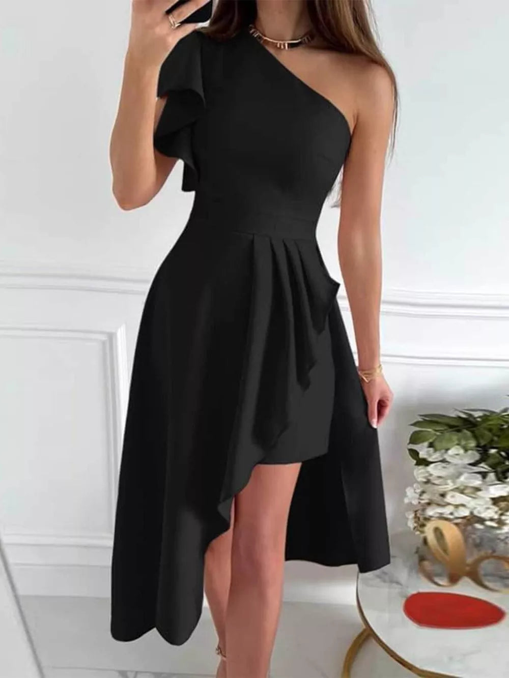 Black asymmetrical ruffle dress with a high-low hem and one-shoulder neckline.