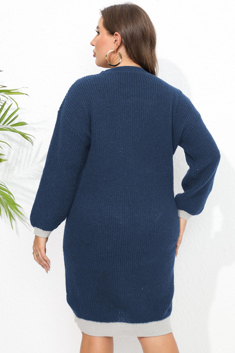 Dark blue ribbed knit dress with contrast trim and long sleeves.