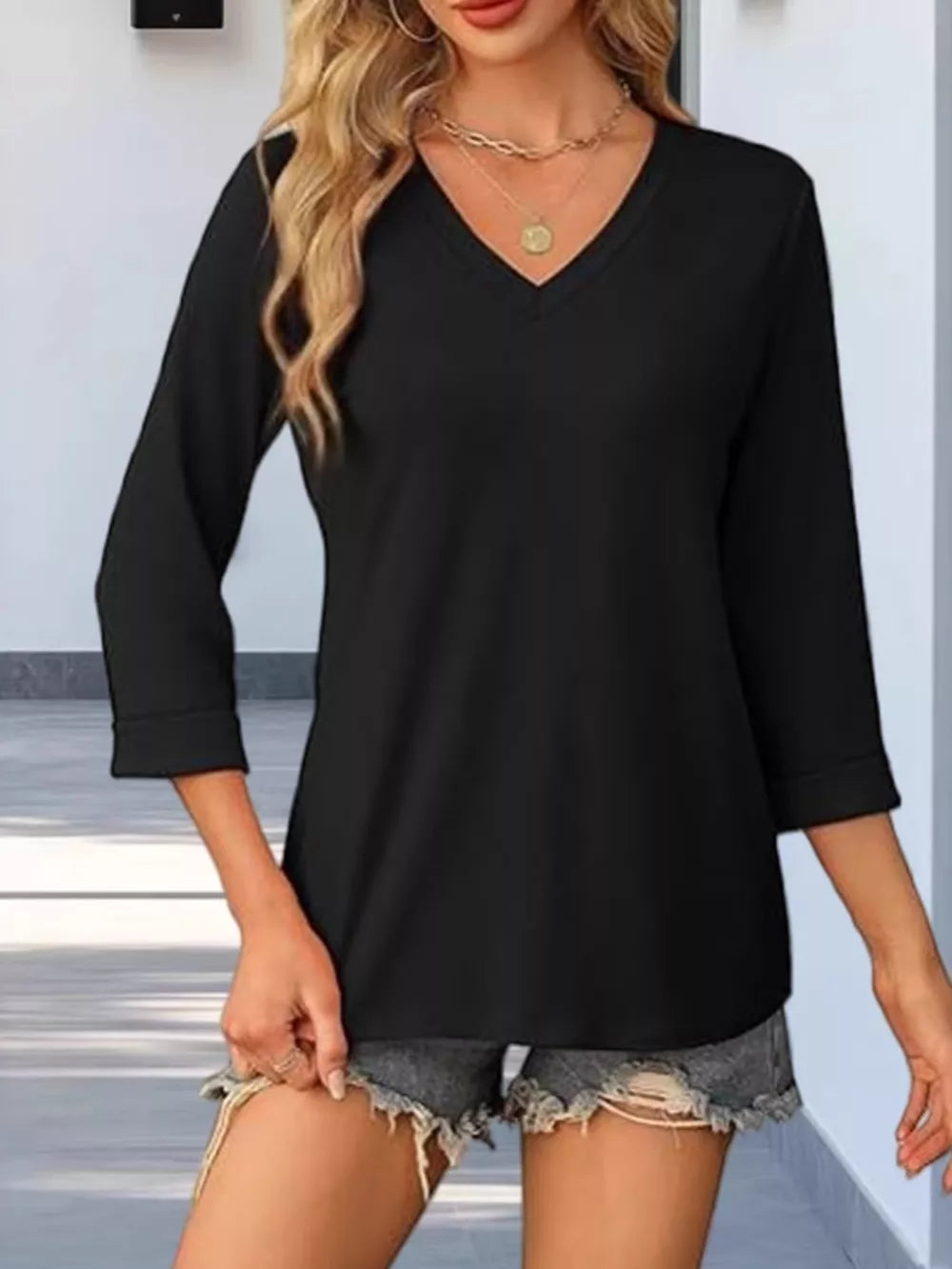 Black V-neck maternity t-shirt with 3/4 sleeves and cuffed hems.