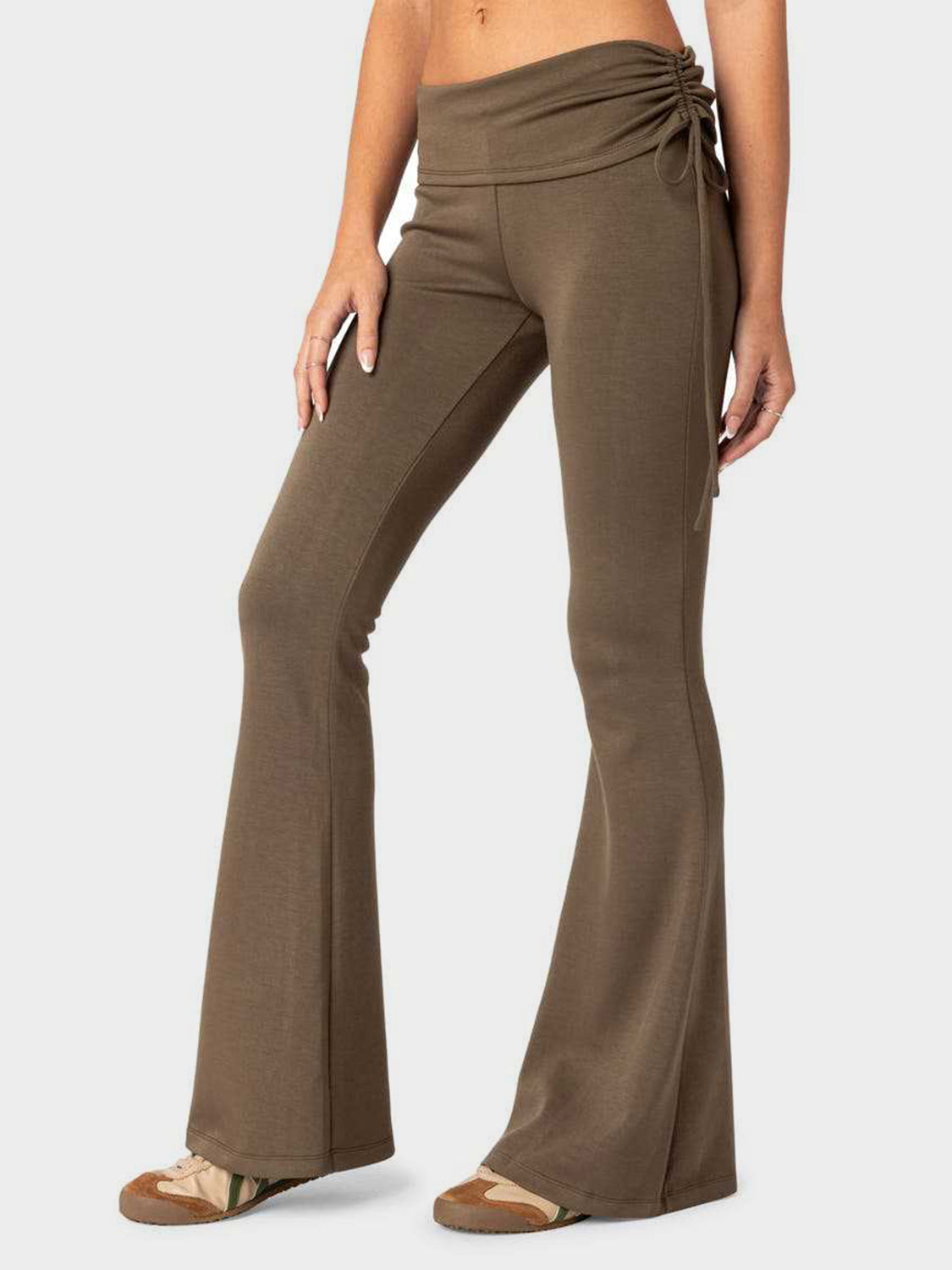 Drawstring waist flare trousers in coffee brown, with a cinched detail on the side.