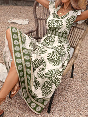 Botanical print V-neck maxi dress in cream with green botanical pattern and border print.