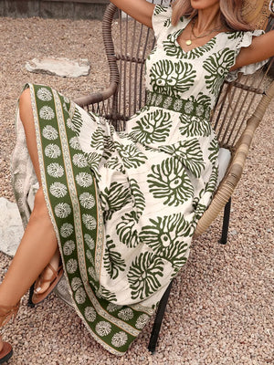 Botanical print V-neck maxi dress in cream with green botanical pattern and border print.