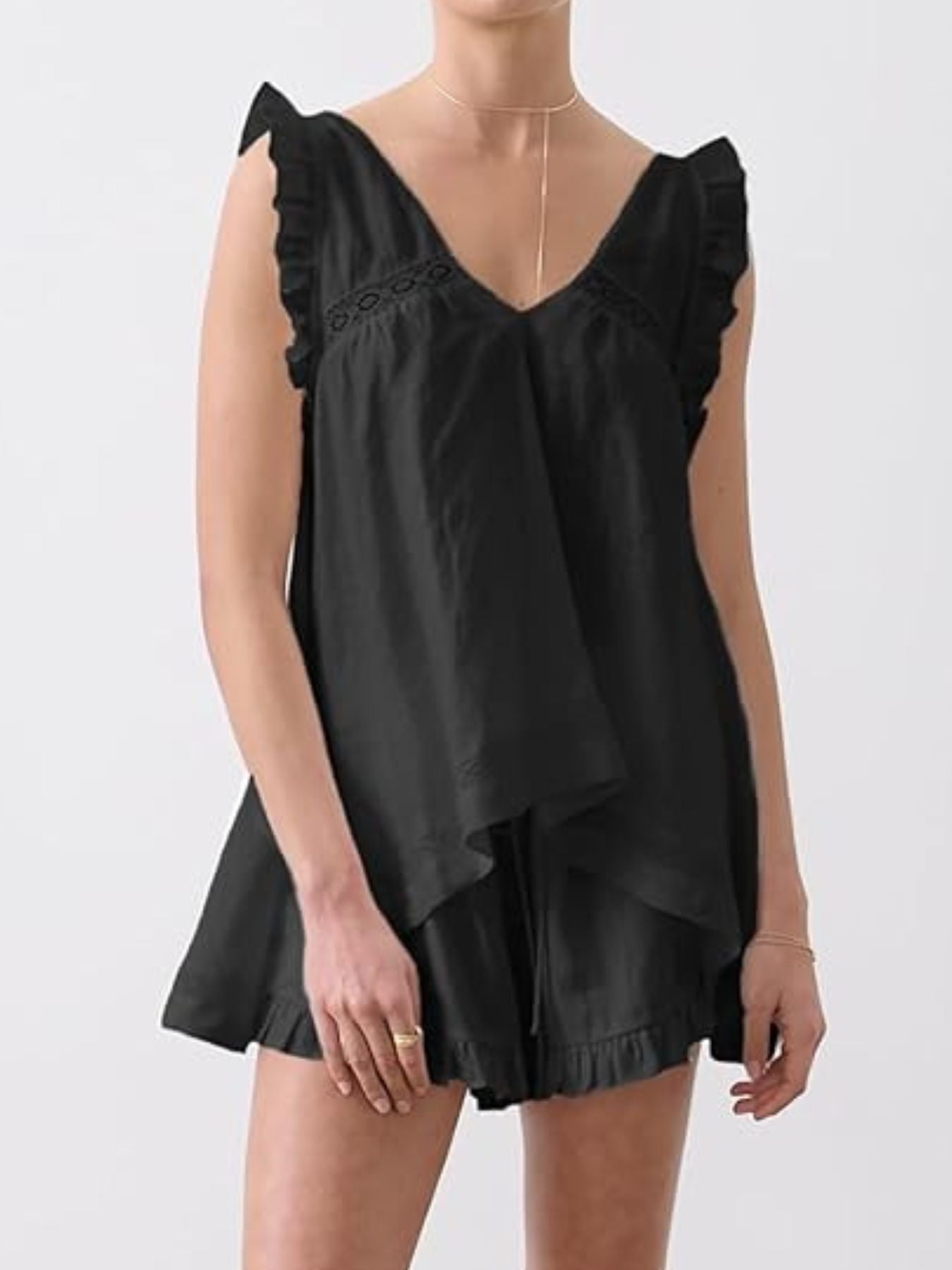 Black ruffled V-neck top and shorts set with lace detail and drawstring waist.