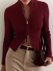 Burgundy ribbed zip-up cardigan with mock neck and silver zipper detail.
