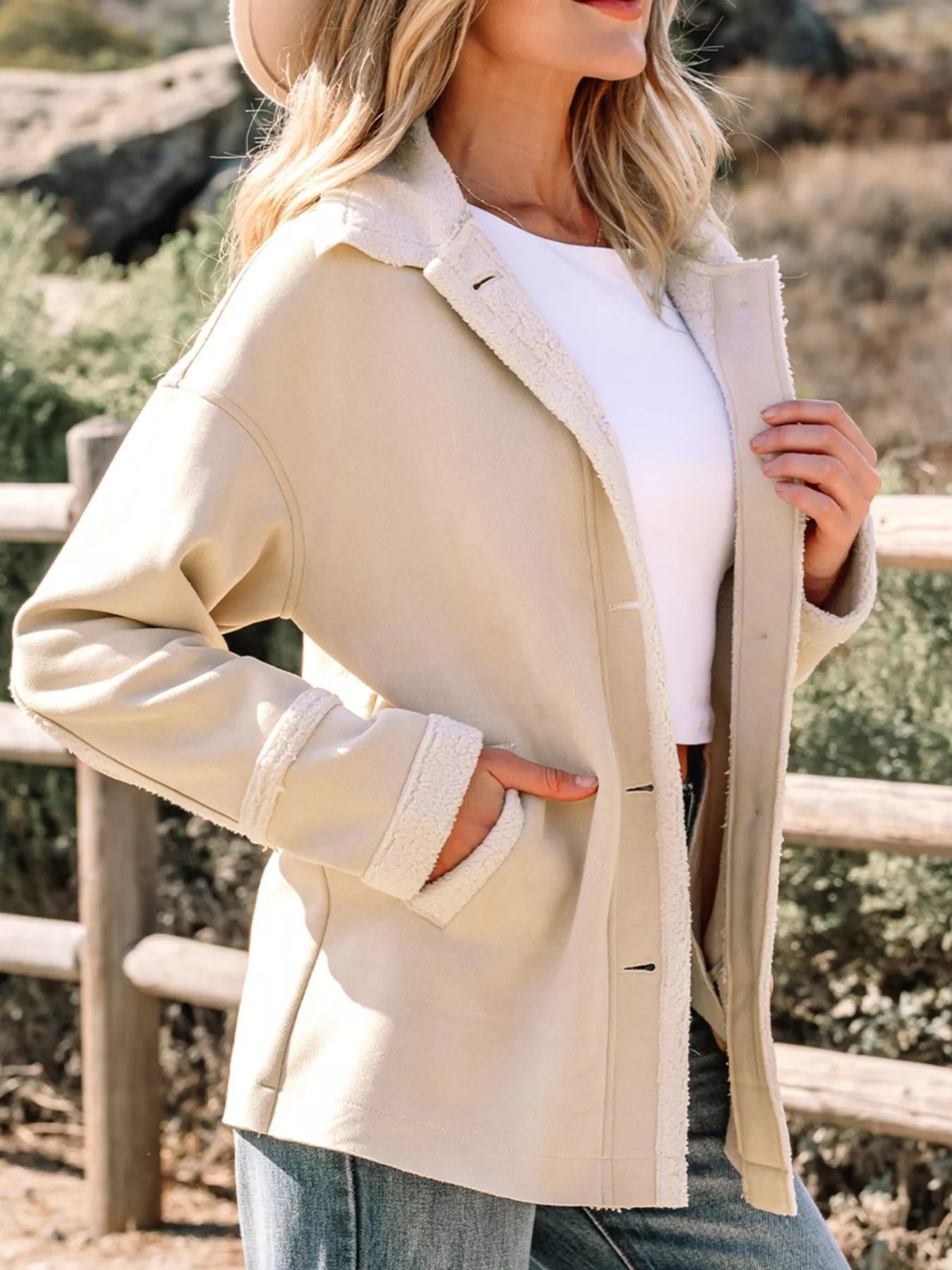 Lined western jacket in eggshell with sherpa trim and button closure.