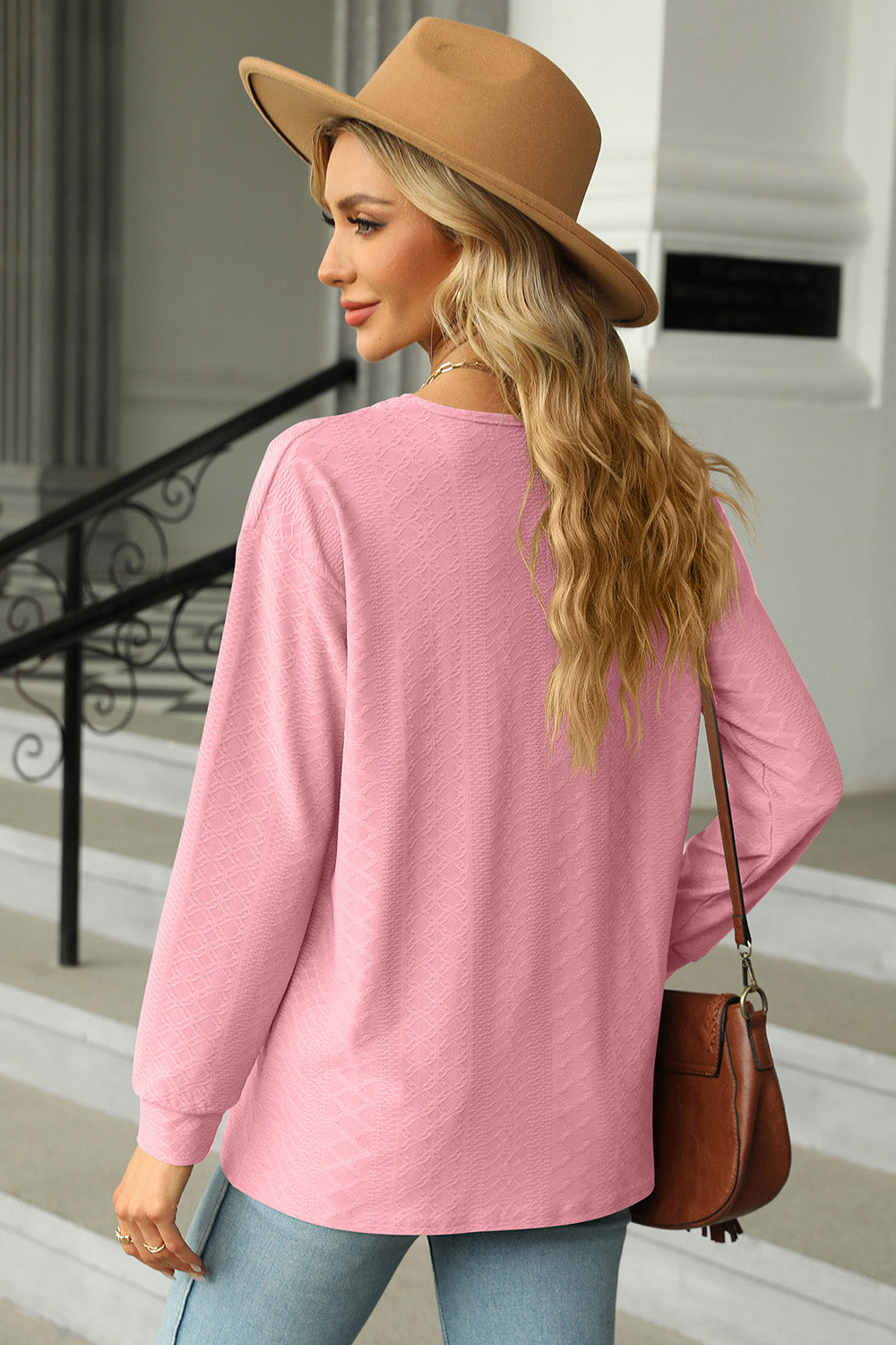 Textured blush pink long sleeve henley top with a V-neck.