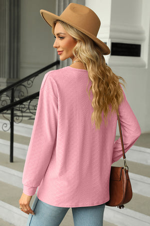 Textured blush pink long sleeve henley top with a V-neck.