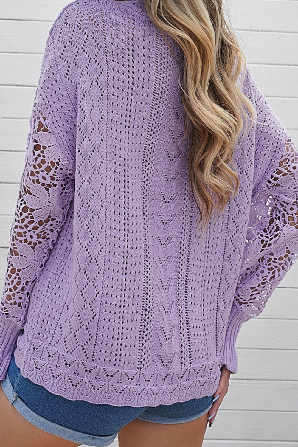 Lavender openwork knit sweater with lace sleeves and intricate stitch patterns.