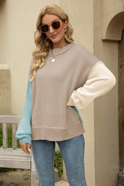 Colorblock knit pullover sweater with beige, cream, and pastel blue acrylic sleeves.