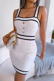 White ribbed knit mini dress with black trim and gold button detail.