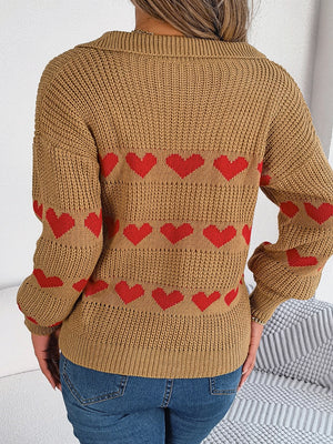 Camel knit polo sweater with red heart stripe pattern and collared neckline.