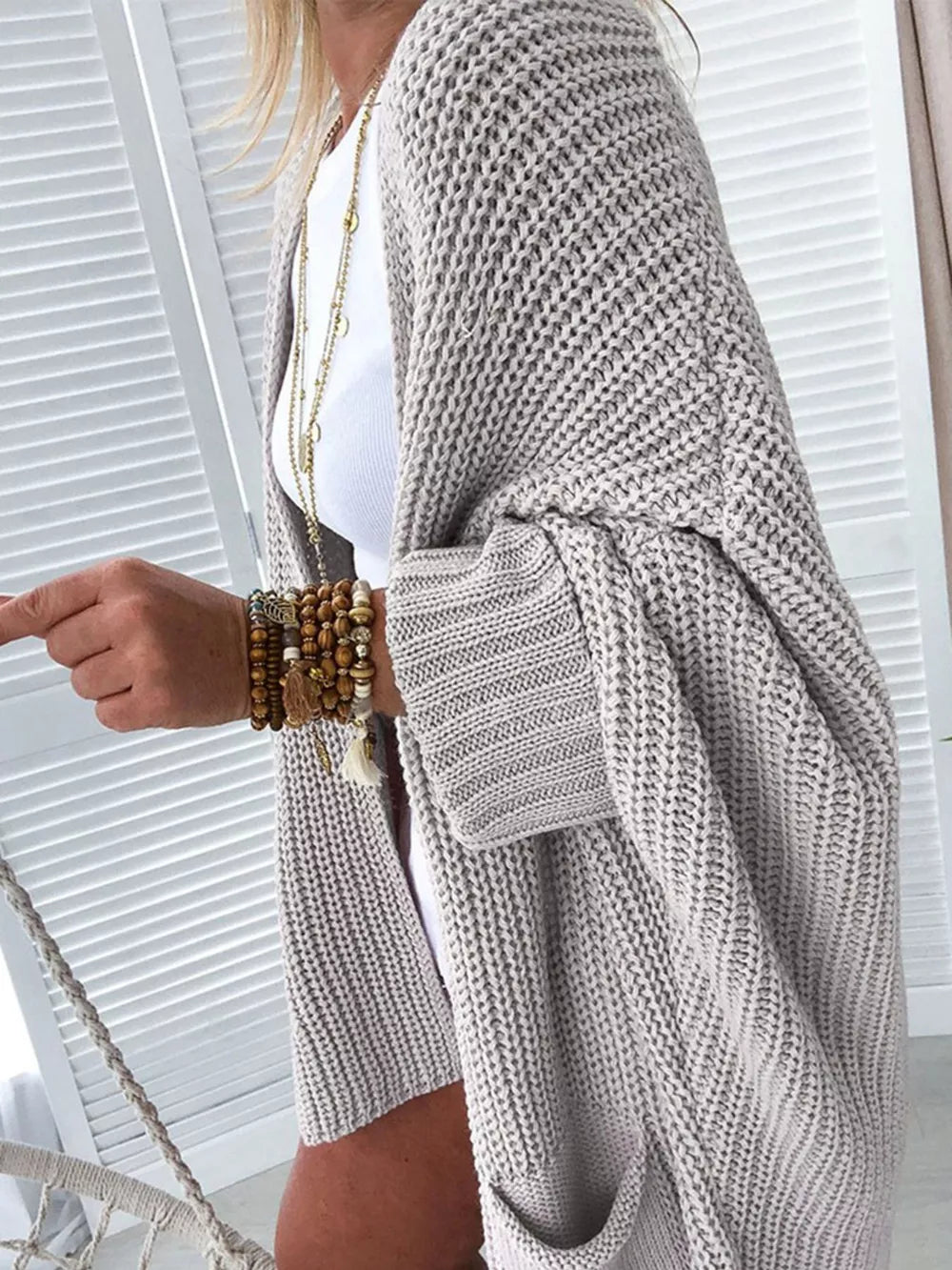 Cozy open front cardigan in light gray acrylic knit with pockets and cuffed sleeves.