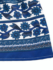 Dark blue floral midi dress with drawstring waist, white fabric with blue floral print and border details.