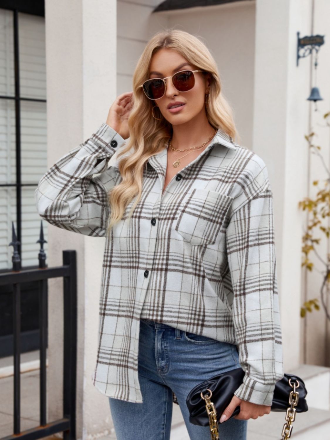 Oversized plaid shirt jacket in light blue with brown checks, featuring a button front and chest pocket.